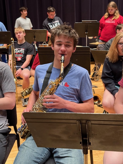 All state band student playing alto saxophone.