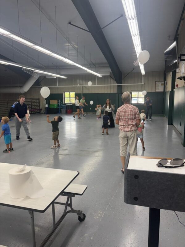 Dr. Coffey, Seniors, and AM Preschoolers playing balloon volleyball.