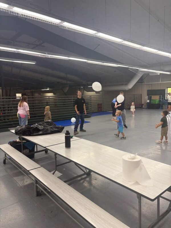 Dr. Coffey, Seniors, and AM Preschoolers playing balloon volleyball.