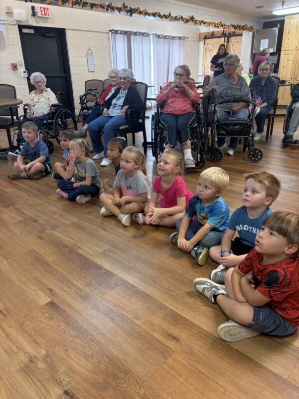 Pre-K and residents listening to book