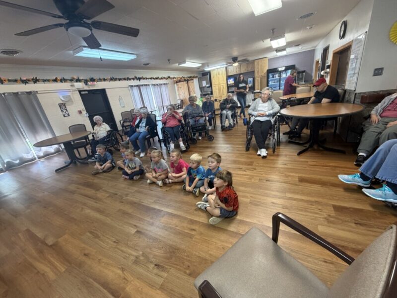Pre-K and residents listening to book