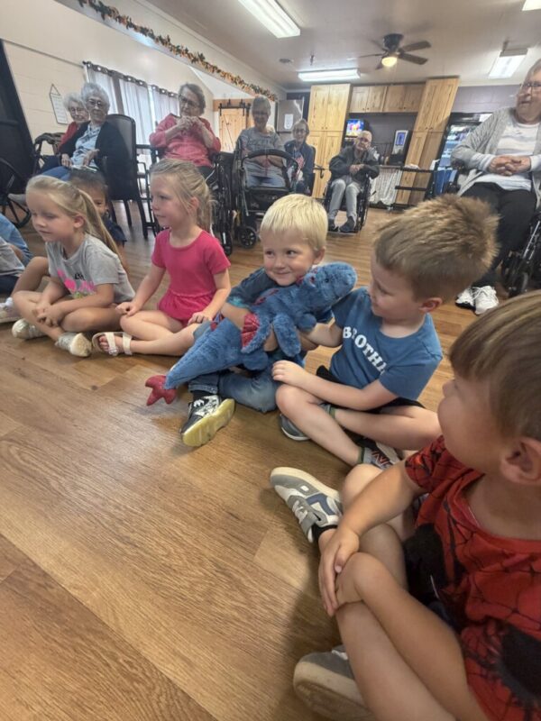 Pre-K and residents listening to book