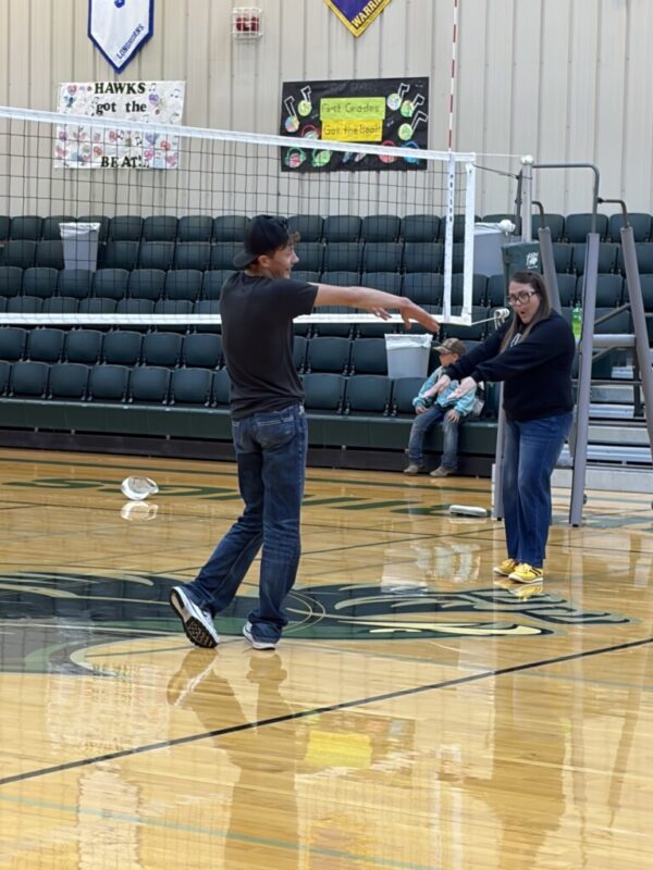 Dr. Coffey and student playing volleyball